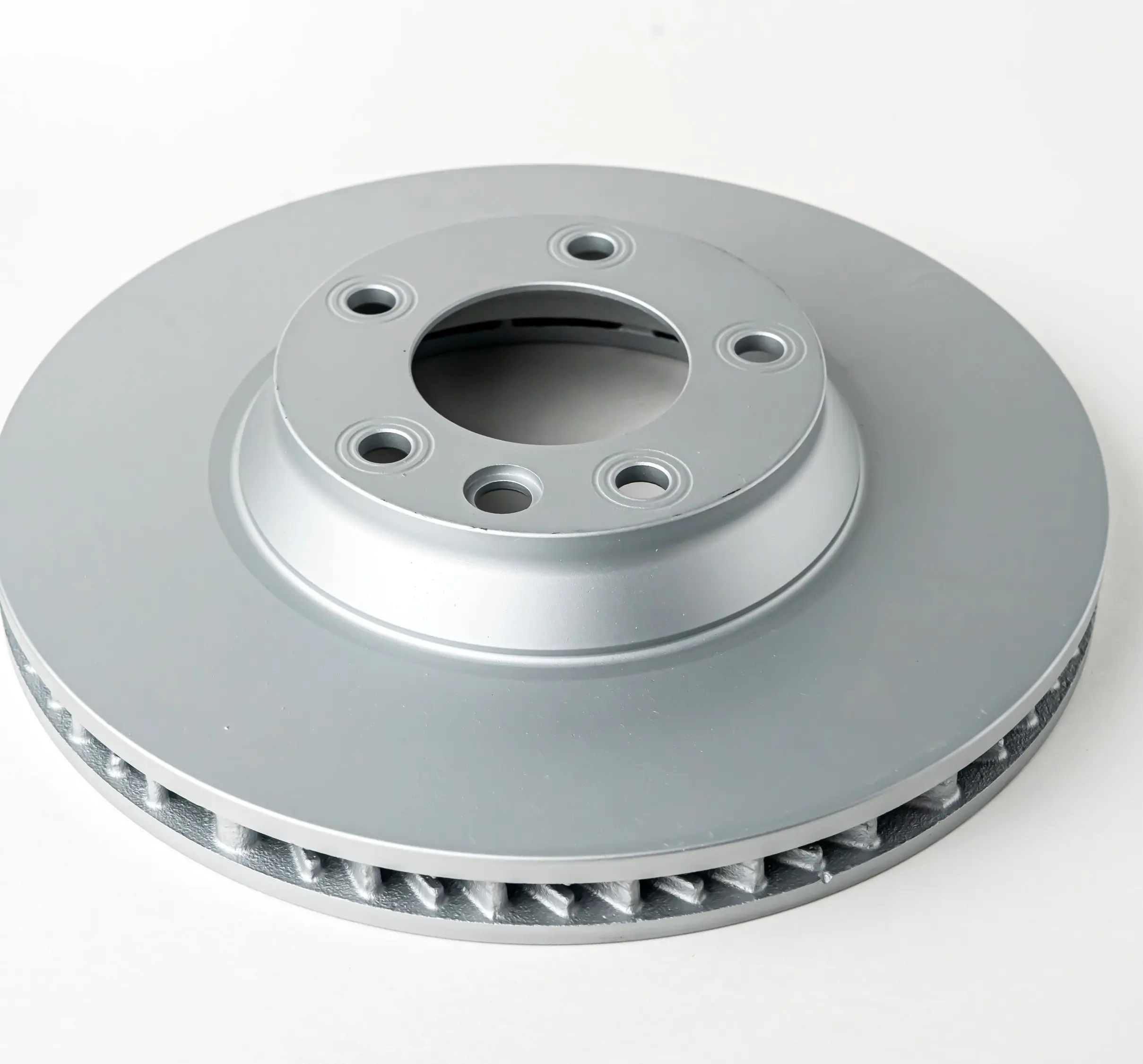 A close-up view of a brake disc showing its vented structure and mounting holes.