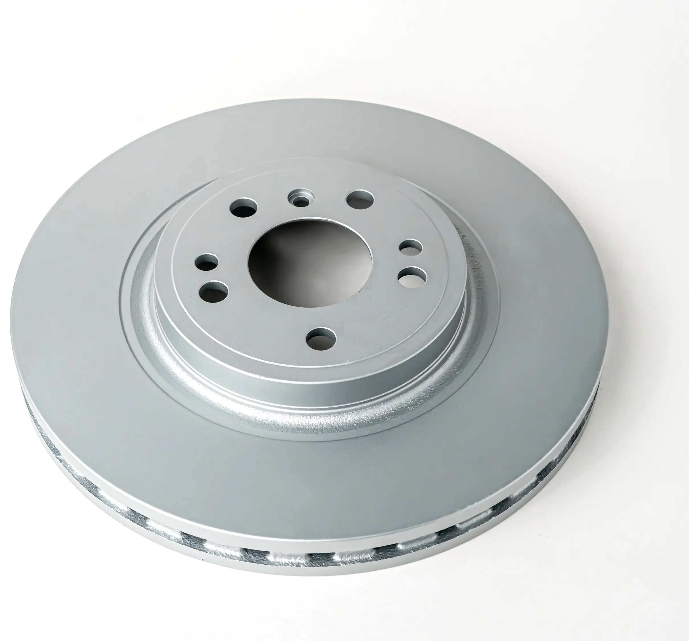 A vented brake disc viewed from an angle, highlighting the central hub with bolt holes and the cooling vents around the outer edge.
