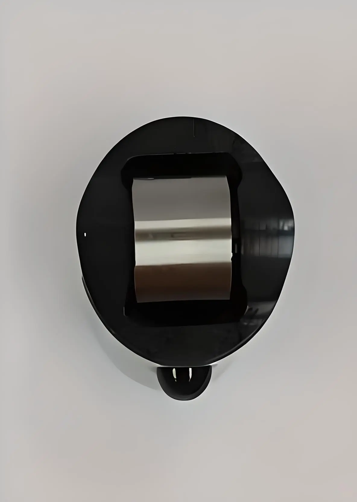 Top view of a metal roller tappet with a cylindrical roller on top, displayed on a white background.