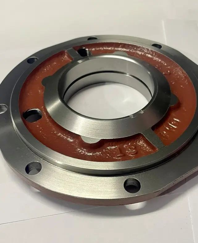 A metal cover component with a red base and multiple bolt holes, displayed on a white background.