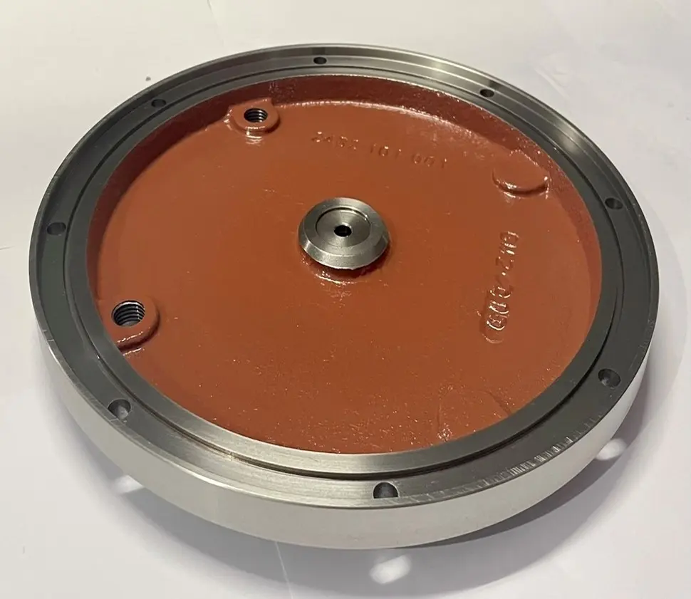 A metal cover component with a flat red base, multiple bolt holes, and a central circular opening, displayed on a white background.