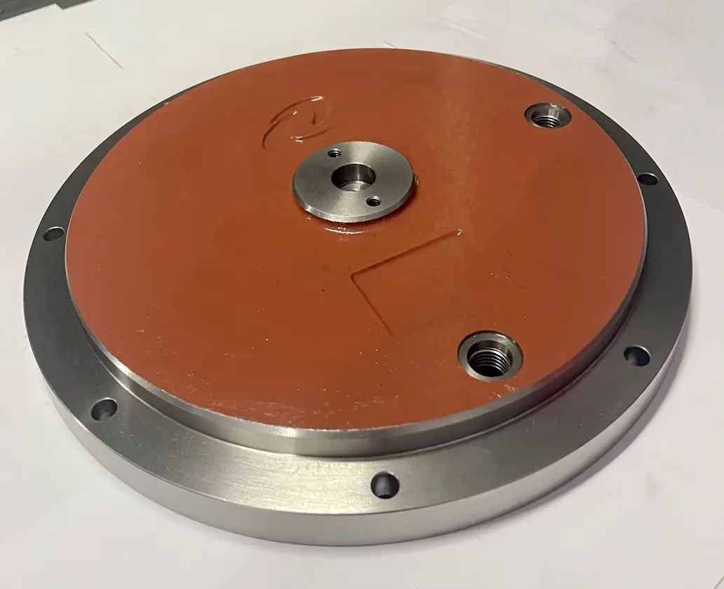 A metal cover component with a flat red base, multiple bolt holes, and a central circular opening, displayed on a white background.