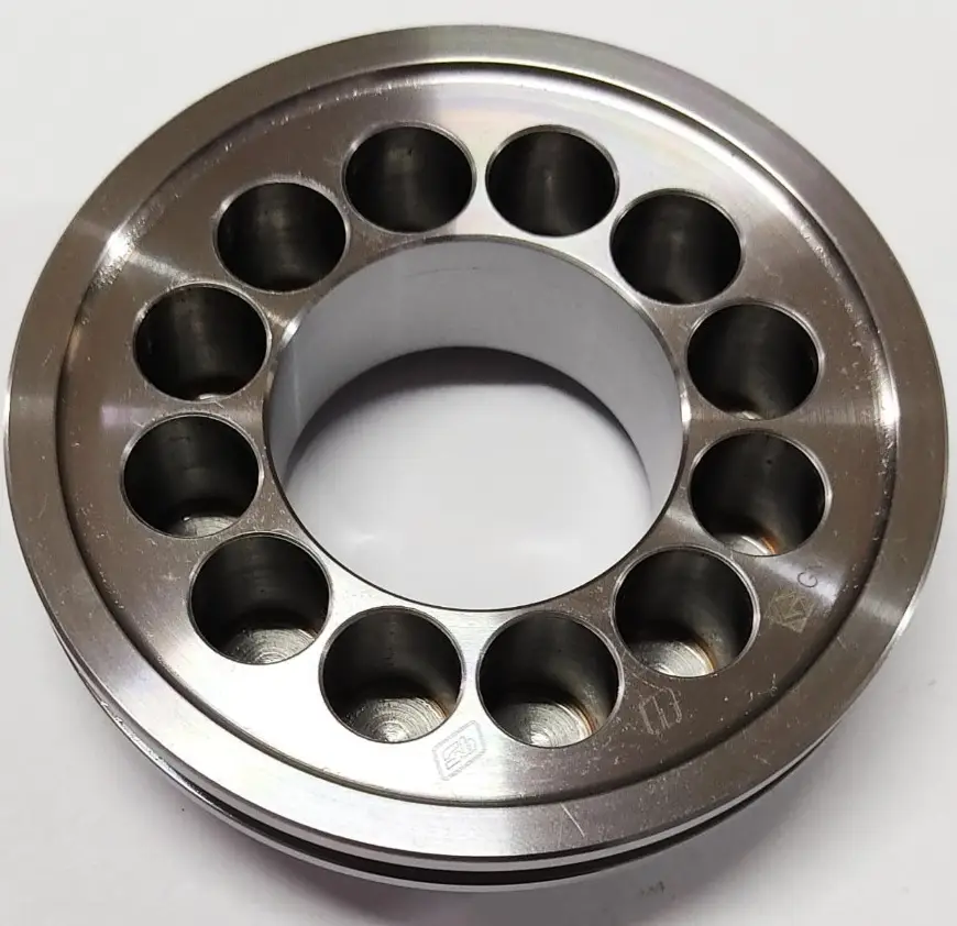 A metal brake piston component with multiple circular openings around its circumference, displayed on a white background, top view.