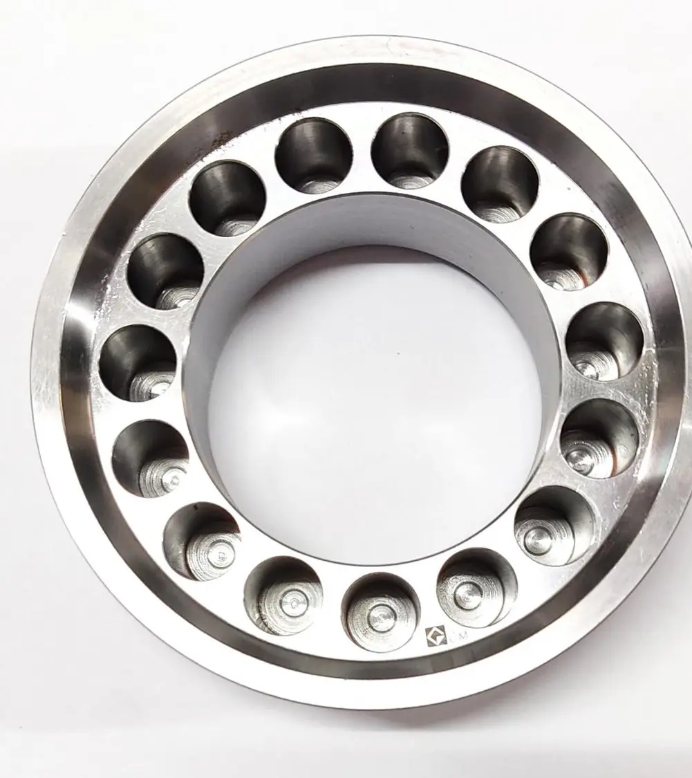 A metal piston component with multiple circular openings around its circumference, displayed on a white background, top view.