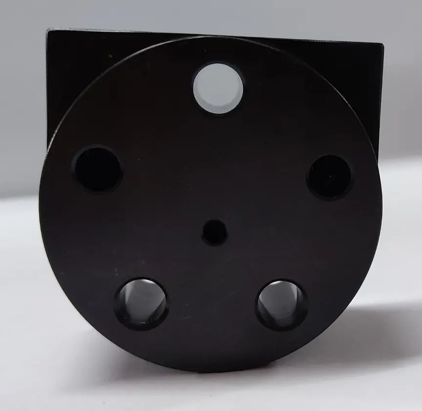 A black metal rear cover component with multiple circular openings, displayed on a white background, front view.