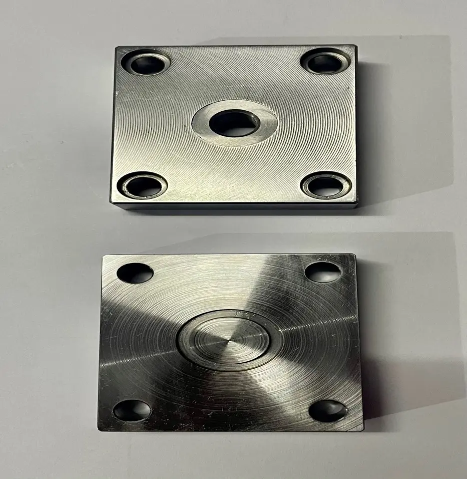 Two metal lids for valve holes with circular patterns and bolt holes, displayed on a white background.