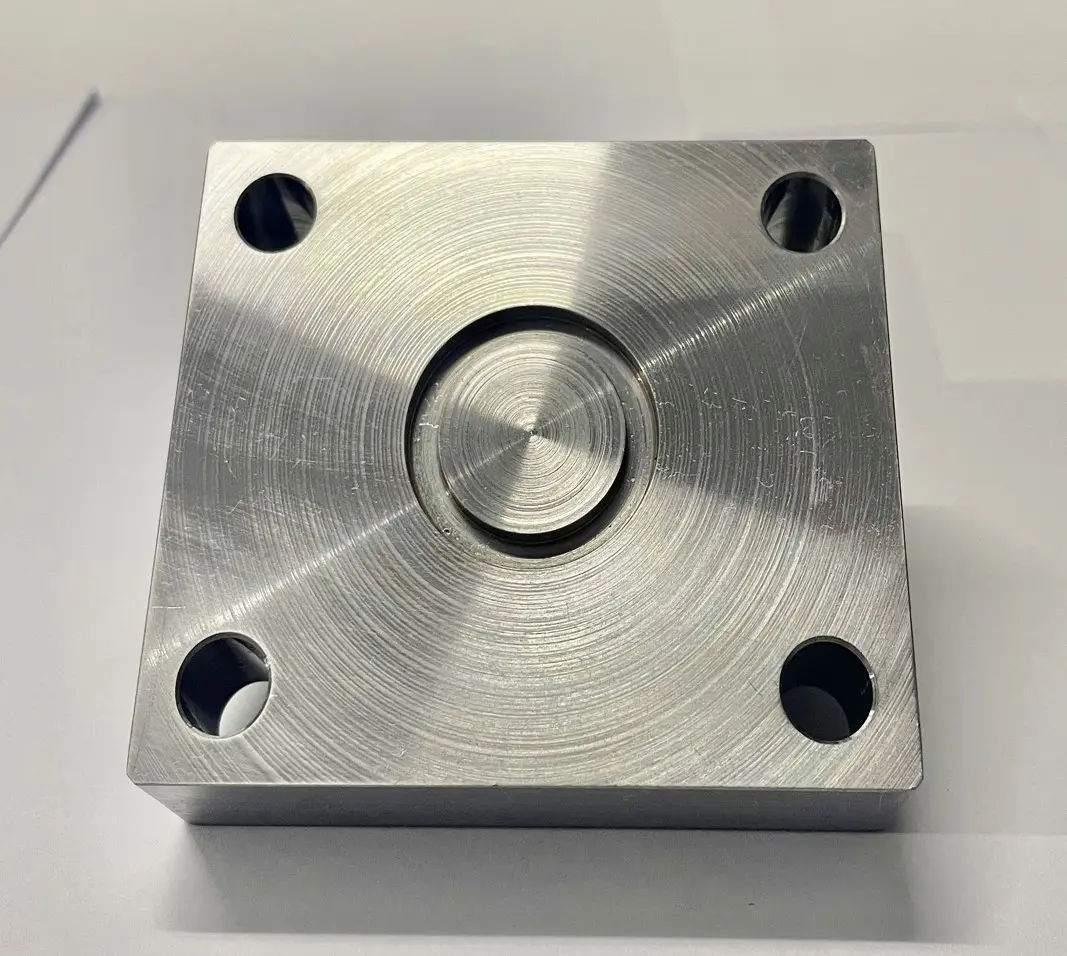 A single metal lid for a valve hole with a circular pattern and bolt holes, displayed on a white background.