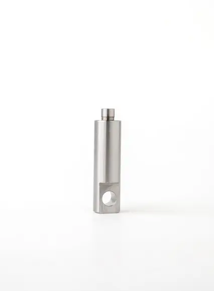 A metal pin component with a short, smooth end and a hole at the base, displayed on a white background.