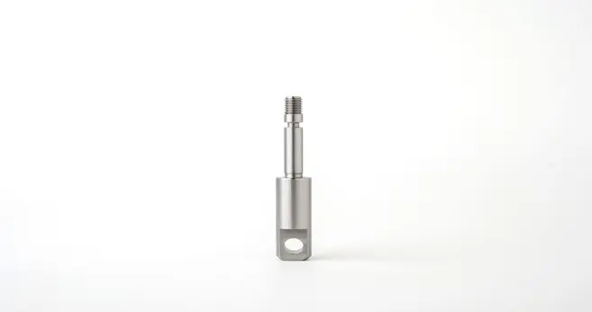 A metal pin component with a threaded end and a hole at the base, displayed on a white background.