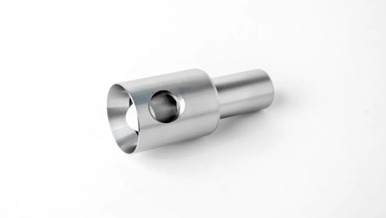 A metal piston guide component for pumps, featuring a cylindrical shape with a side hole and an open end, displayed on a white background.