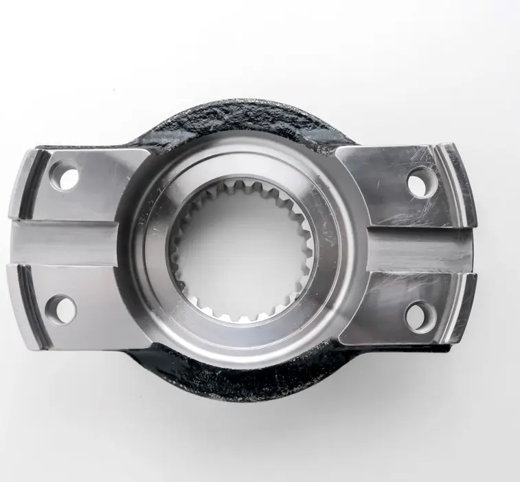 A metal yoke component with a splined circular opening and bolt holes, featuring additional metal brackets, displayed on a white background.